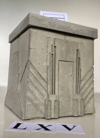 Concrete boxurn with art deco relief all around